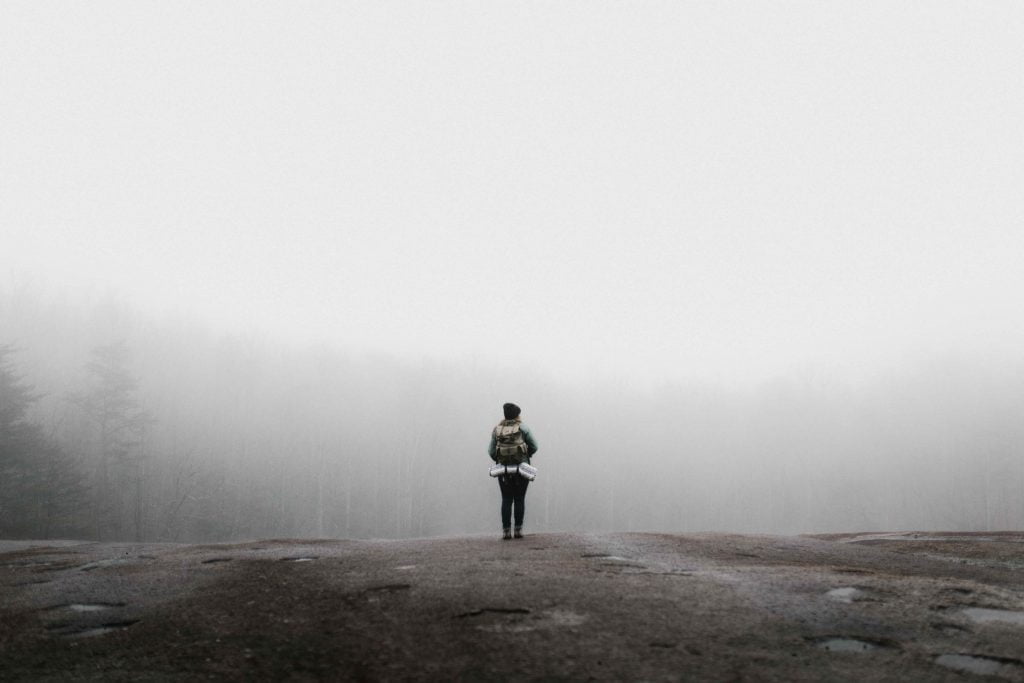 woman walking in the fog