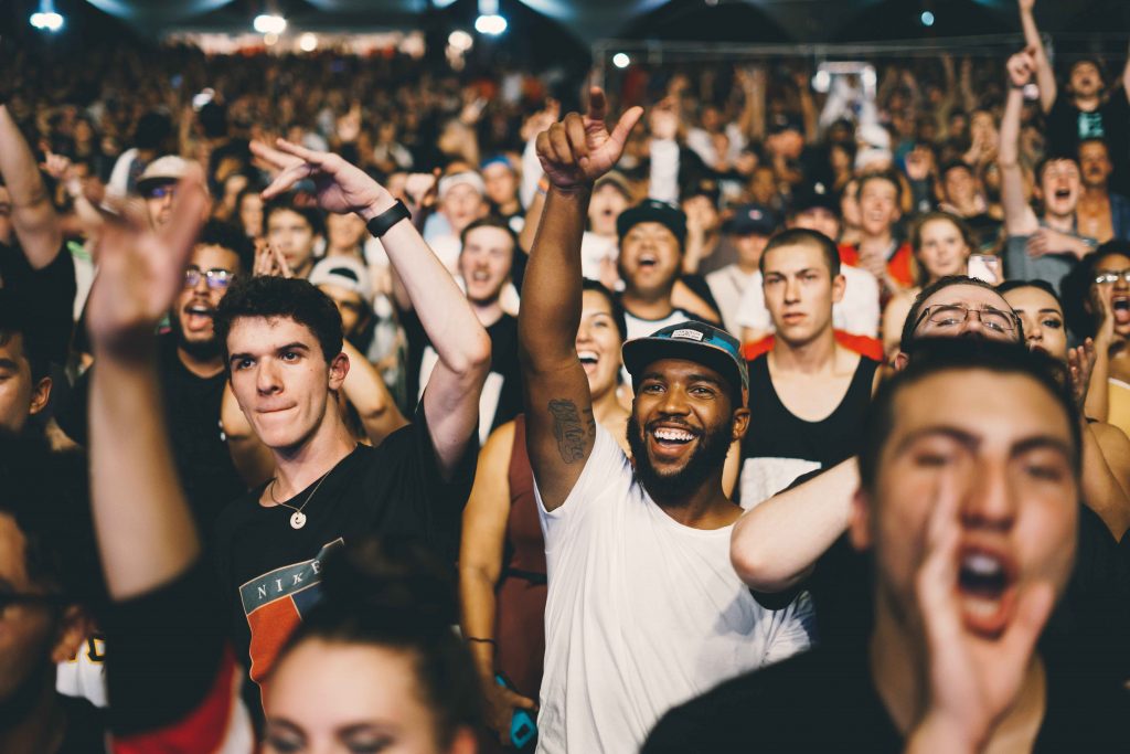 people cheering at a concert