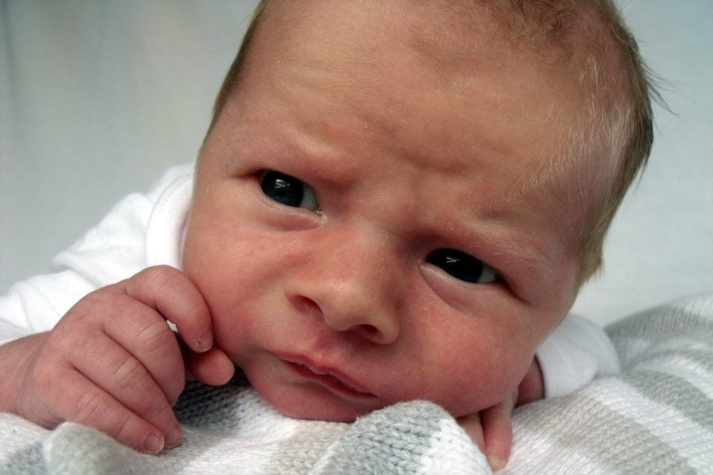 a baby with a skeptical expression