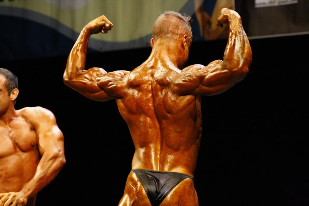 A man poses at a bodybuilding competition